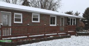 Brick home with snow on the front porch, winter