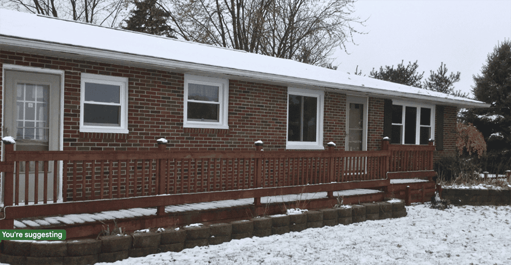 Brick home with snow on the front porch