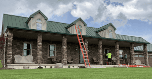 house with green roof and new windows, signs